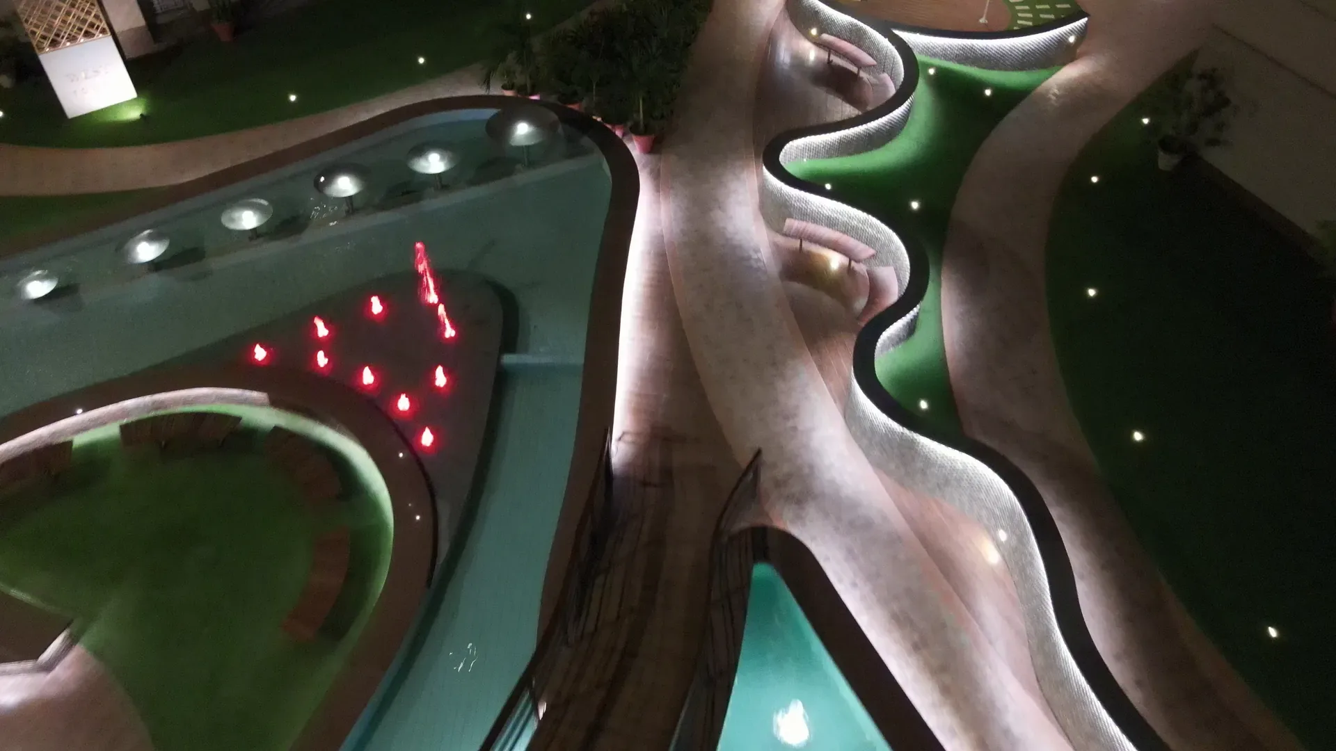 The promenade after dark, its edges traced in light.