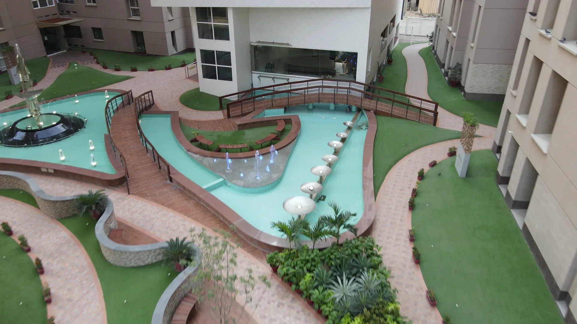 A timber bridge crossing the reflecting pools below the clubhouse.