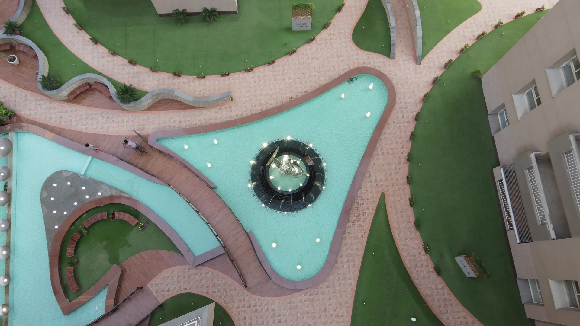 The podium water garden from above, its pools cut into lawn and paving.